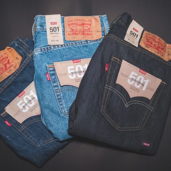 blue denim jeans on black textile