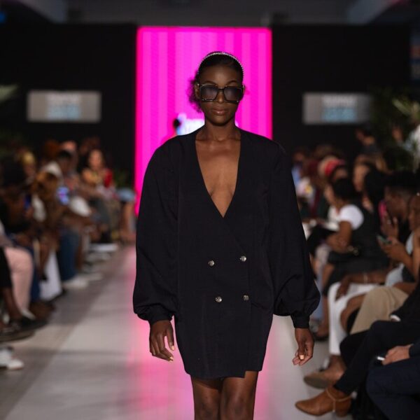 A model walks the runway in a black dress.