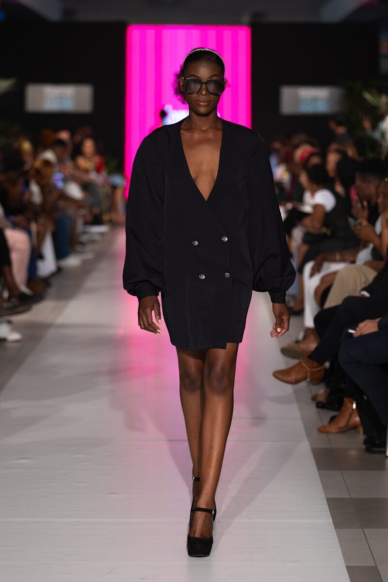 A model walks the runway in a black dress.